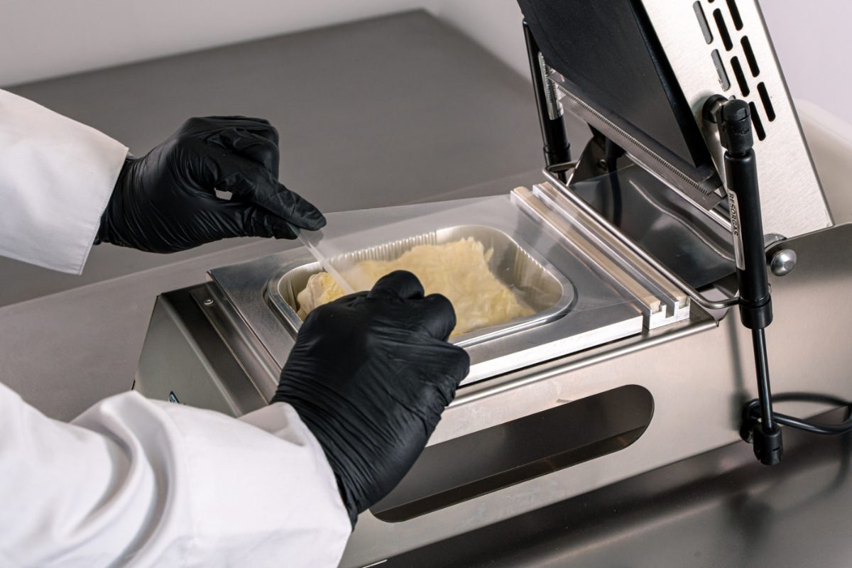 Placing a tray in the RP-RA150 manual tray sealer